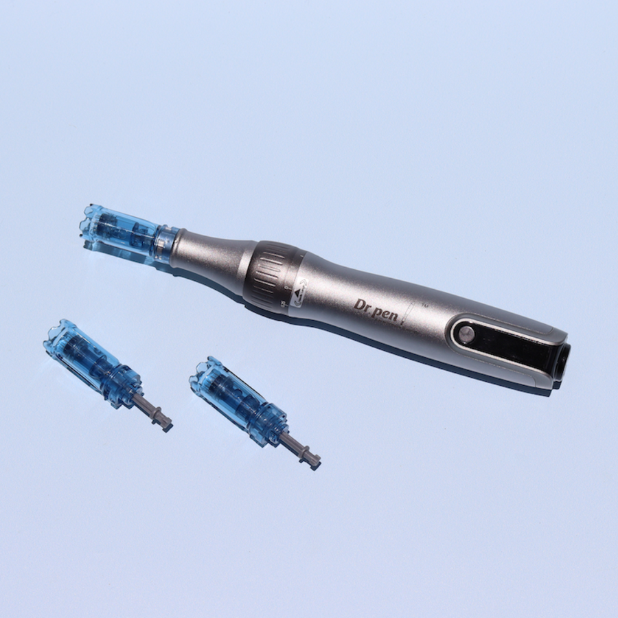 Silver Dr. Pen device with one blue cartridge attached and two spare cartridges on light blue background.