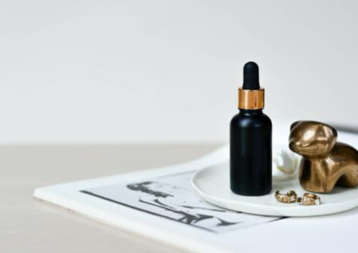 black serum bottle sitting on a trinket dish 