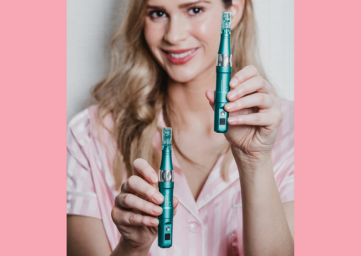 a woman holding two dr. pen 16s microneedling devices while smiling