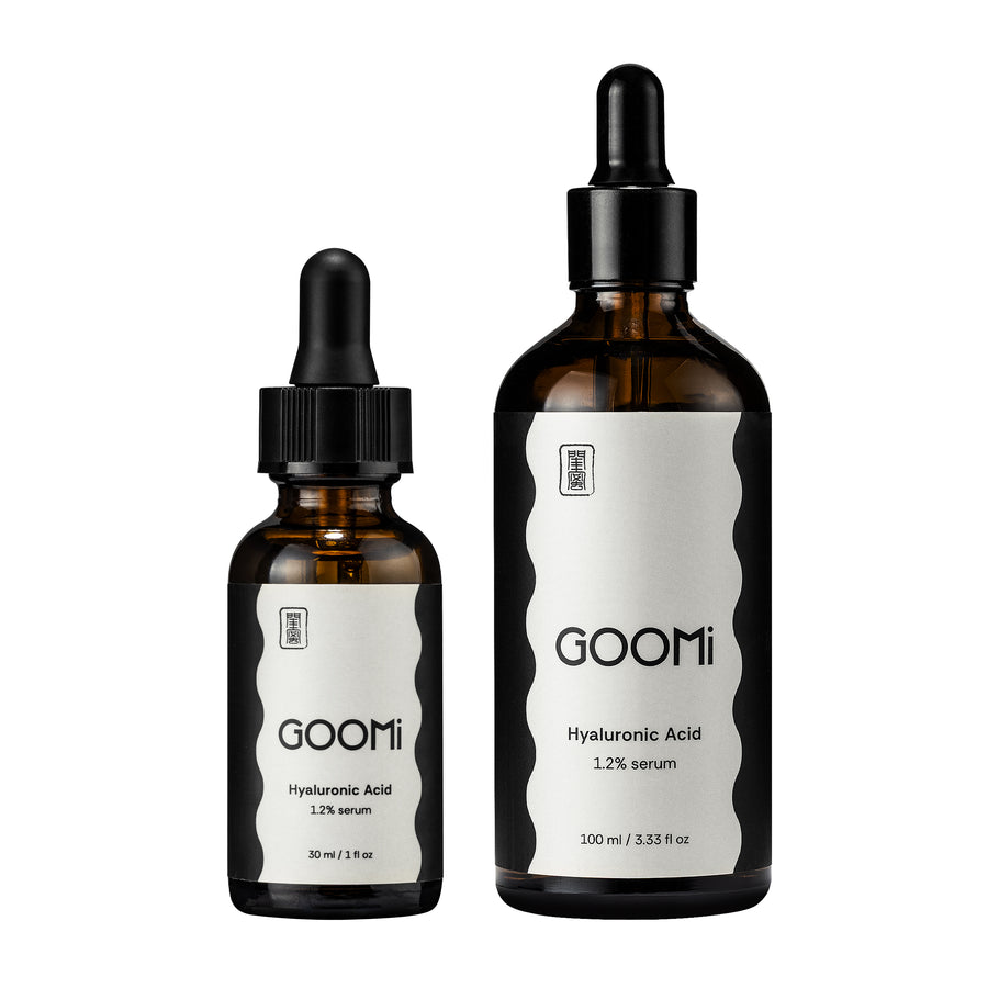 2 glass dropper bottles of GOOMi Hyaluronic Acid serum, one 30 ml and one 100 ml, with black caps and white labels on a plain white background.