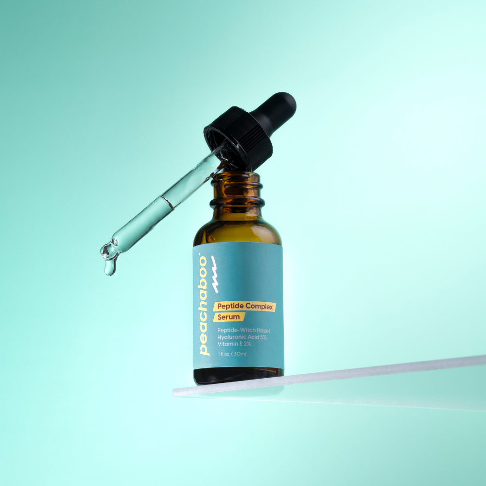 Bottle of Prochaba Peptide Complex Serum with dropper on a light blue background