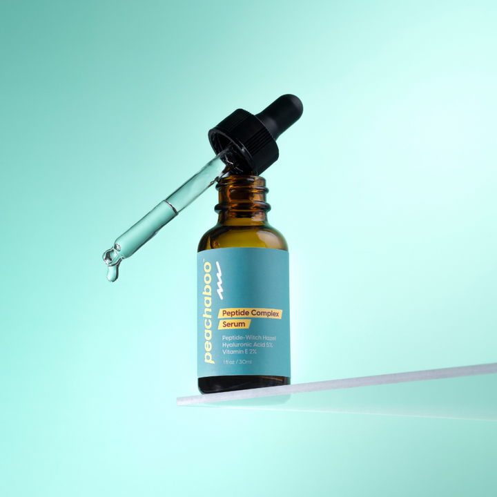 Bottle of Prochaba Peptide Complex Serum with dropper on a light blue background