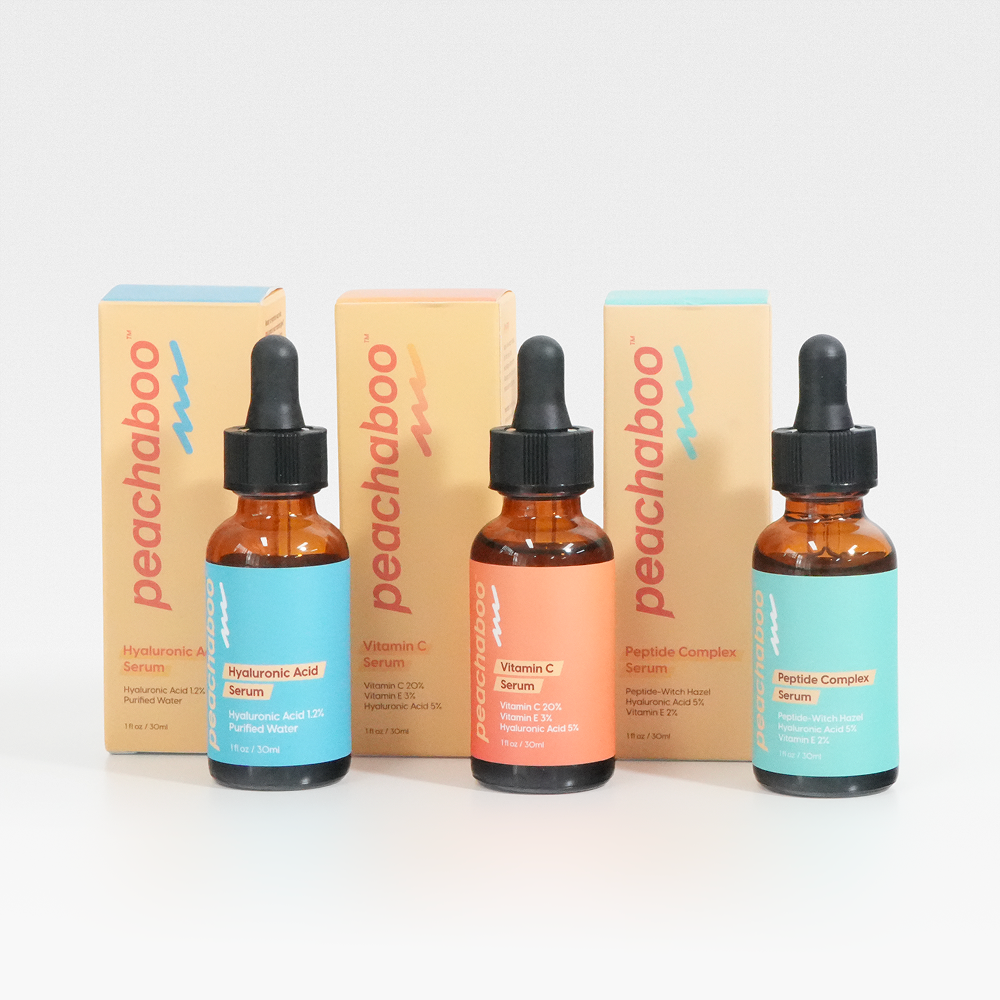 Three peachaboo skincare serum bottles with their packaging on a white background